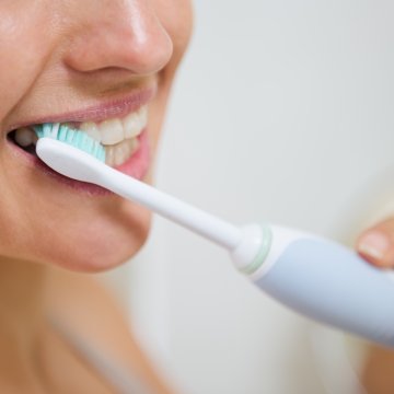 Close up of someone brushing their teeth